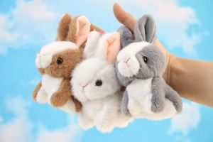Close-up of three mini plush rabbits in brown, white and grey with soft faux fur texture