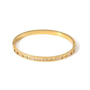 Elegant 18K gold-plated titanium steel hollow bangle with cubic zirconia crystals