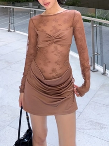 Detailed view of sheer mesh bodice with floral embroidery and ruched brown skirt