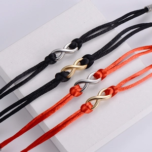 Infinity woven rope bracelets in red and black with gold and silver titanium steel charms