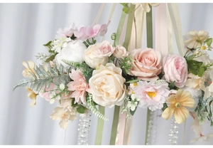 Close-up of pastel floral hanging ornament with satin ribbons and crystal beads