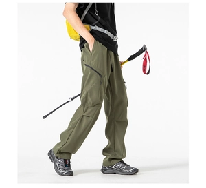 Detail of olive green cargo pants featuring multi-pocket design and reinforced knee structure