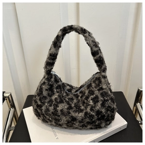 Detailed close-up showing soft black and grey plush leopard print texture on a shoulder bag