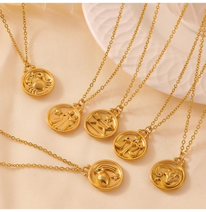 Detail of six gold zodiac pendants with star engravings on an elegant silk background
