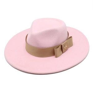 Pink wool fedora hat with light brown ribbon bow and gold bee charm detail