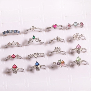 Detailed grid of various fashion rings featuring zircon flowers, pearls, and colorful crystals