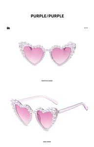 Detail view of purple heart sunglasses with pearl inlay and gradient lenses