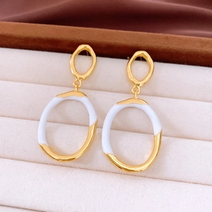 Macro shot of two-tone gold and silver interlocking oval drop earrings on jewelry box