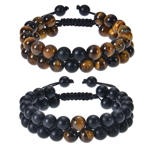 Detail of adjustable double-layer tiger eye and matte black stone beaded bracelets