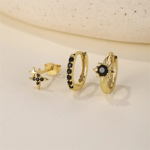 Close-up of gold 925 silver earring set featuring black zircon stars and huggie hoops