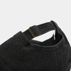 Detail of vintage washed cotton baseball cap with adjustable antique bronze buckle