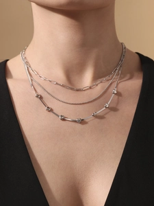 Detailed view of layered 5A zircon heart necklace with paperclip and snake chains
