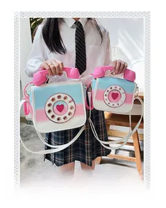 Detail of pink and blue gradient telephone bag with receiver handle and heart dial