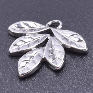Macro shot of silver stainless steel leaf pendant with detailed vein texture for DIY jewelry