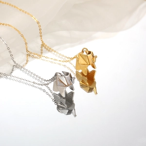 Geometric origami elephant pendant necklace in gold and silver finish with reflection