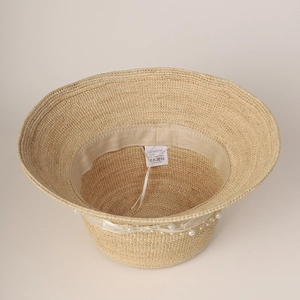 Wide brim raffia sun hat with white lace ribbon and faux pearls in natural beige