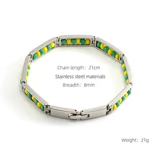 Detail of 8mm stainless steel bead bracelet showing green and yellow beads in gold settings