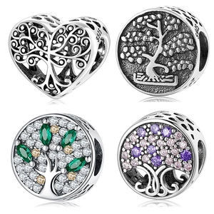 Detailed macro view of S925 sterling silver heart beads with colorful zircon tree motifs