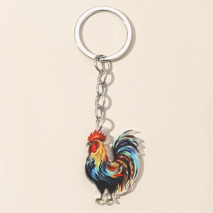 Colorful acrylic rooster keychain with silver metal ring on a minimalist beige background