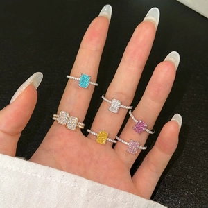 Close-up of S925 silver rings with colorful ice flower cut zircon stones on a model's hand