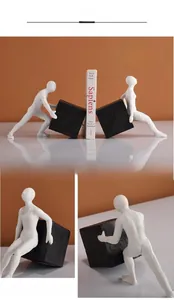 Detailed view of modern resin human figurine bookends with matte black and white finish