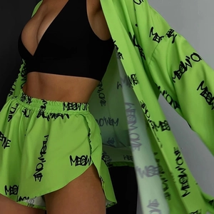 Detail of neon green loungewear set with graffiti print and casual long-sleeve cardigan