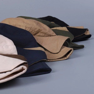Multi-color cotton bucket hats for women in beige, navy, and khaki on blue background