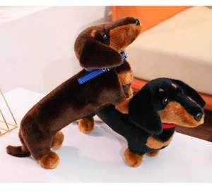 Detail of plush dachshund dog toys with colorful collars in a playful stacked pose