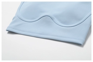 Detail of light blue ribbed yoga top featuring wavy stitching and high-elastic fabric
