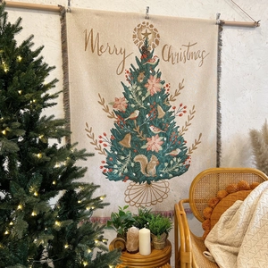 Detail of Christmas tree woven tapestry featuring tassels and warm holiday home decor texture