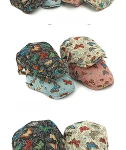 Detail of ethnic jacquard newsboy cap showing colorful butterfly pattern and metal buckle