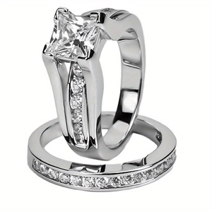 Detailed macro view of silver wedding ring set featuring princess cut diamond and pave band