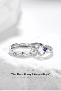 Close-up of silver moon and star couple rings featuring blue gemstone and zircon inlay