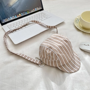 Macro shot of striped 5-panel hat shaped crossbody bag with adjustable strap