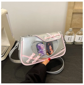 Close-up of silver ita bag with pink trim featuring a heart-shaped clear display window