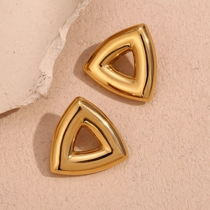 Macro detail of geometric hollow triangle stud earrings in 18K gold plated stainless steel