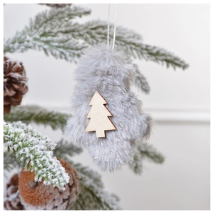 Gray plush mitten ornament with wooden tree detail hanging on snowy Christmas tree branch