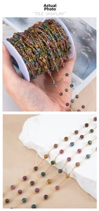 Detailed macro view of multi-color gemstone beads with gold stainless steel jewelry chain