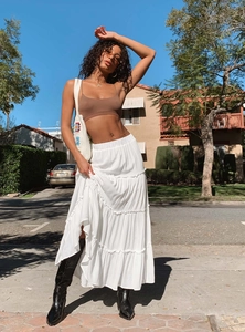 Detail of layered white tiered maxi skirt with pleated ruffles for a summer street style