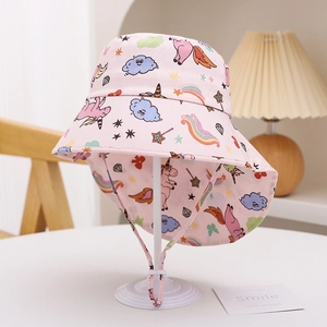 Detailed close-up of pink kids sun hat featuring unicorn prints and chin strap