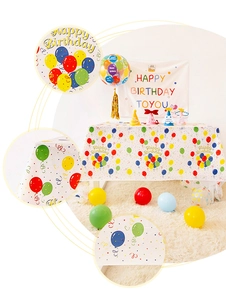 Close-up detail of Happy Birthday themed tablecloth with colorful balloons and ribbon patterns