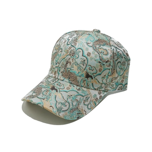 Detail of premium golden brocade baseball cap with traditional Chinese cloud patterns