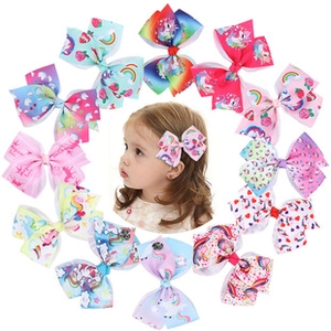 Detailed set of colorful bow hair clips with unicorn and rainbow patterns for children