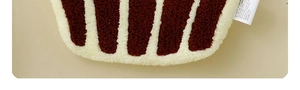 Close-up of thick striped coral fleece hand towel showing soft texture and care label