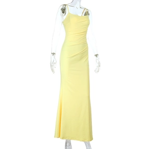 Detail of ruched yellow maxi dress featuring thin spaghetti straps and slim fit design
