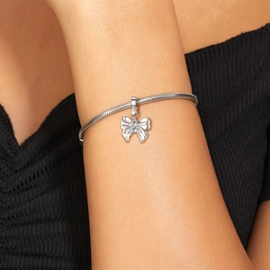 S925 sterling silver bow pendant with small diamonds on a sleek snake chain bracelet