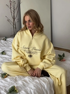 Women's light yellow two-piece sportswear set with half-zip sweatshirt and casual pants