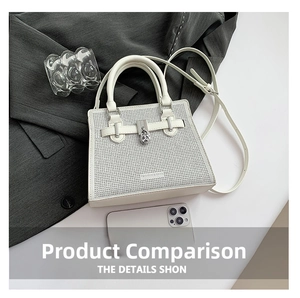 Detail of white sparkling crossbody bag with silver buckle next to phone for size scale