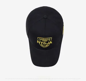 Top down view of black cotton baseball cap with detailed yellow embroidery and stitching