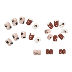 Cute pink and white press-on nails with cartoon cat paw prints and cat face designs